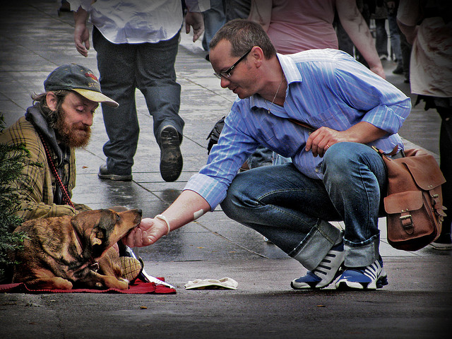 Homeless man on street with dog
