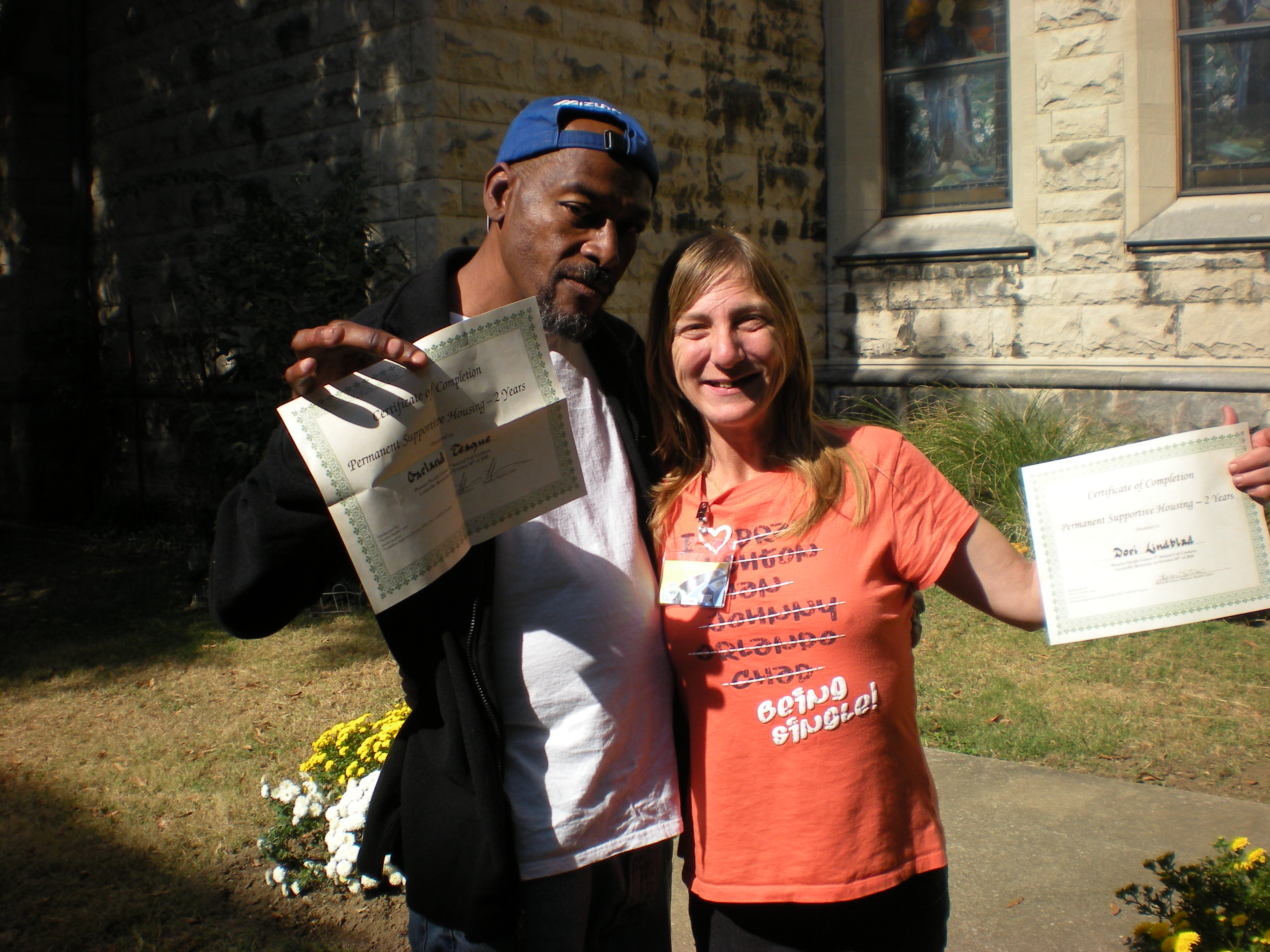 At the program's 2010 fall cookout, Garland Teague and Dori Wilson received certificates for recognition of two successful years in housing. 