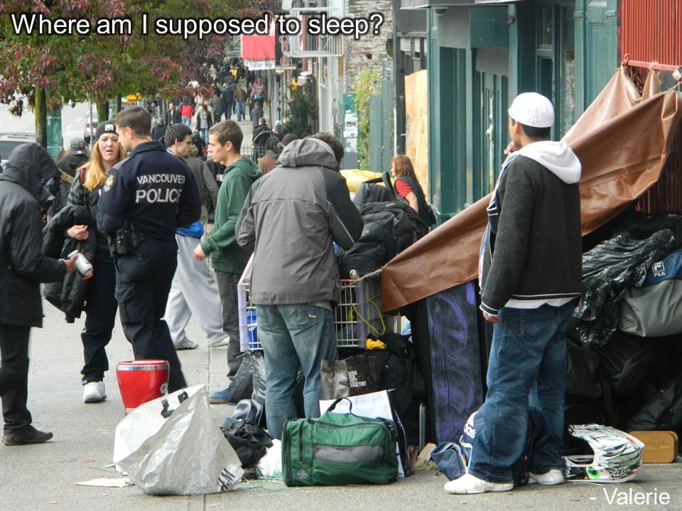 An officer talking to homeless on the side walk