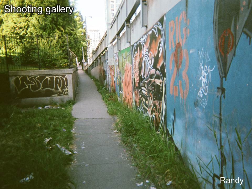 Small pathway lined with graffiti