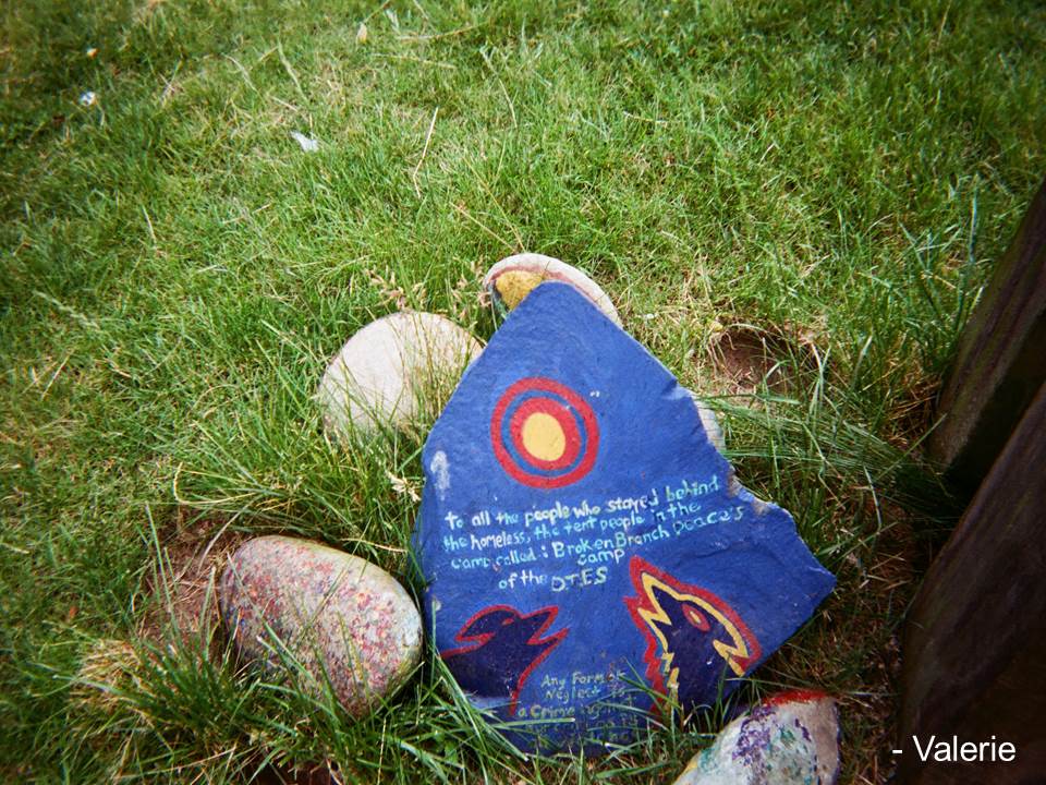 Note on a rock that reads: To all the people who stayed behind the homeless, the tent people in the camp called: Broken Branch Peace's camp of the DIES
