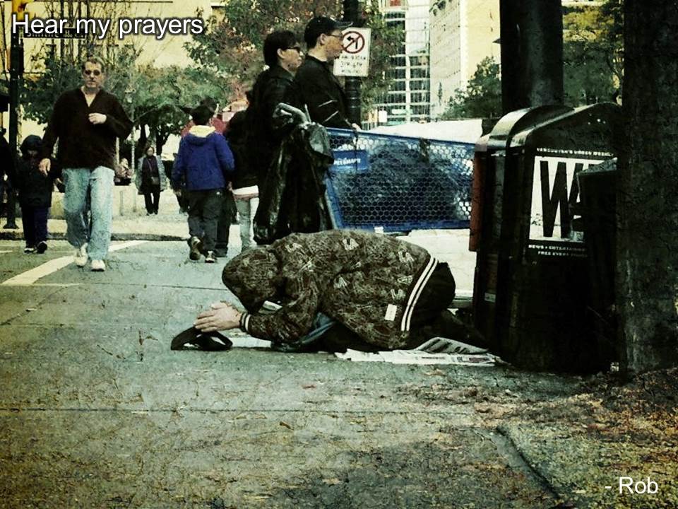 Homeless man on the side of the road on his knees, begging